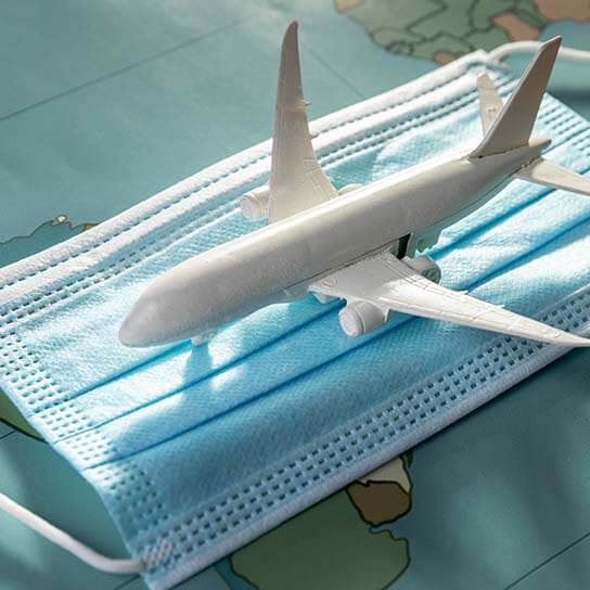 Travel health services in Niles, IL – airplane on mask symbolizing pre-travel care