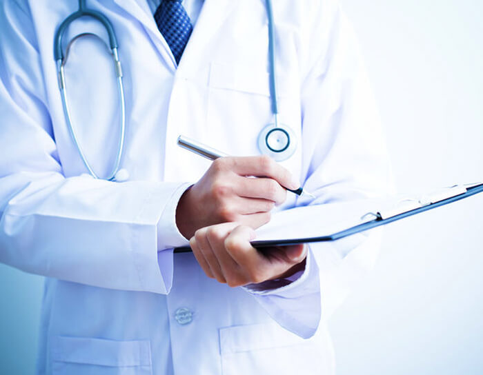 Medical professional at Marpeh Urgent Care and Family Health Center in Niles, IL, documenting patient care for urgent and work-related health services